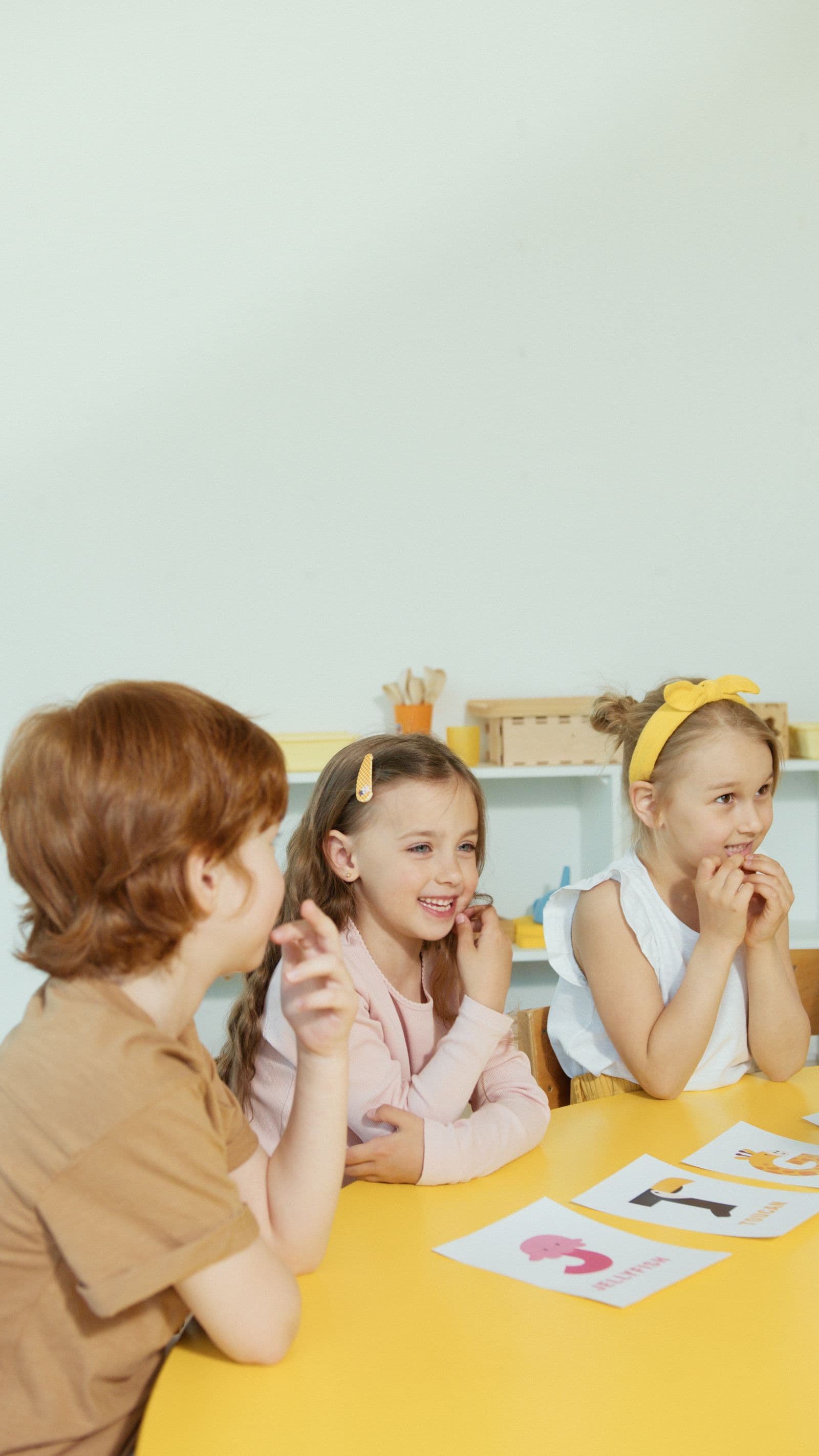 Children at a table with picture cards during a language activity